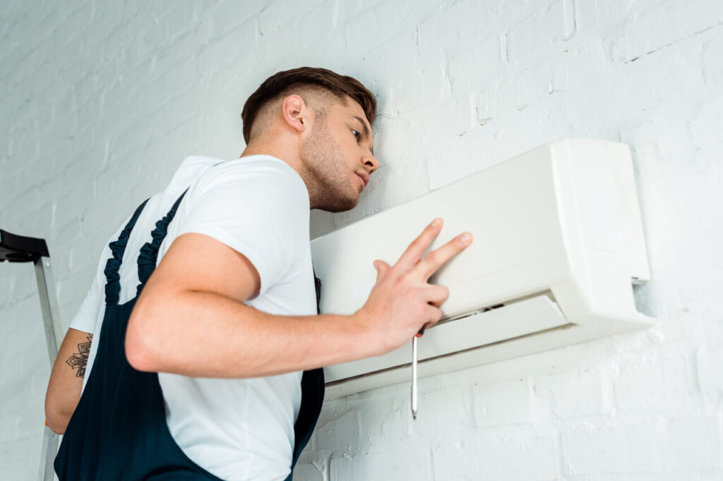 rsz handsome worker installing air conditioner utc jpg